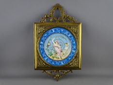 A 19th CENTURY CIRCULAR PORCELAIN HANDPAINTED PLAQUE in a gilt brass frame with leaf swag mounts, 40