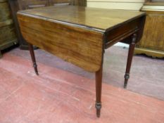 A GEORGIAN MAHOGANY TWIN FLAP PEMBROKE TABLE with single end drawer on turned supports with brass