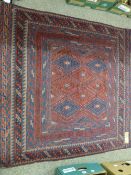 A CAZAK RUG, blue and red ground, multiple bordered with central diamond pattern, 118 x 116 cms