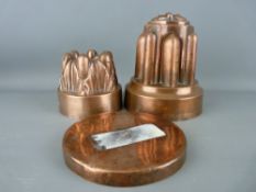 TWO VICTORIAN COPPER JELLY MOULDS, 10 and 17 cms high, the latter with original base cap, both
