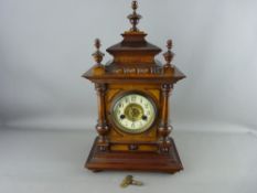 A CIRCA 1900 GERMAN WALNUT CASED MANTEL CLOCK, Wurttemberg make, fourteen day strike movement on a
