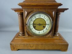 A GERMAN VINTAGE OAK ARCHITECTURAL STYLE MANTEL CLOCK with Junghans brass movement striking on a