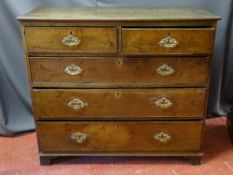A GEORGIAN OAK CHEST OF TWO SHORT OVER THREE LONG DRAWERS with pierced brass backplates and swing