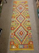 A VEGETABLE DYE WOOL SHOBI KILIM CARPET RUNNER, bright multi-coloured with triple diamond centre and