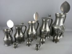 AN EXCELLENT SET OF TEN FRENCH PEWTER FLAGONS with double acorn thumbpieces, graduating from 26
