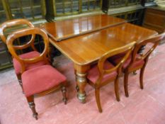 A WELL POLISHED VICTORIAN MAHOGANY PULL-OUT DINING TABLE with additional leaf and four balloon