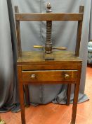 AN ANTIQUE MAHOGANY BOOK PRESS, a single frieze drawer with turned wooden knobs, the whole raised on