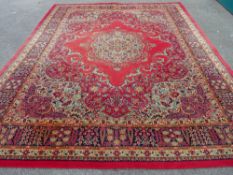 A WOODWARD GROSVENOR WILTON WOVEN CARPET, red ground with extensive floral pattern and multiple