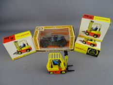A BRITAIN'S GERMAN SCOUT CAR, no. 9783 and three Dinky conveyancer forklift trucks, nos. 404, all