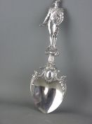 A 925 CONTINENTAL SILVER DECORATIVE SPOON with wide bowl, having leaf decoration leading to a well