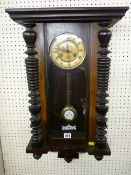 A WALNUT CASED VIENNA STYLE PENDULUM WALL CLOCK, 71 x 36 cms
