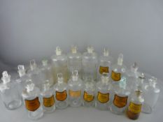 A COLLECTION OF TWENTY ANTIQUE CHEMIST'S BOTTLES with stoppers, most having labels