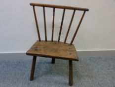 PRIMITIVE WELSH STICK CHAIR on three turned legs and with a six spindle back