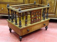 A VICTORIAN WALNUT THREE SECTION CANTERBURY having a single base drawer with inlay detail, spindle