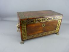 A REGENCY ROSEWOOD TEA CADDY with pierced brass banding, lion mask ring handles and hairy paw