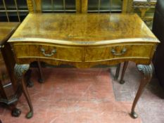 A REPRODUCTION WALNUT SERPENTINE FRONT HALL TABLE having frieze drawers on carved knee cabriole