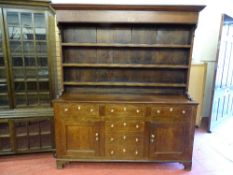 A 19th CENTURY OAK NORTH WALES DRESSER with three shelf rack over a 'T' arrangement of six pine