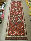 A SUZNI KILIM CARPET RUNNER, tonal reds with multiple diamond pattern and Greek Key style border,
