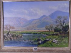 PHILLIP STANTON oil on canvas - North Wales riverscape with grazing sheep, signed in full, 34 x 50