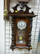 A WALNUT CASED VIENNA STYLE PENDULUM WALL CLOCK, 72 x 38 cms