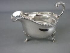A SILVER SAUCE BOAT with 'C' scroll handle on three hoof feet, Birmingham 1937, 7.4 troy ozs