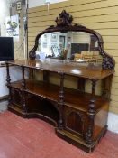 A HIGH VICTORIAN MAHOGANY SERVER with carved dog's head and fruit and vine detail to a mirrorback