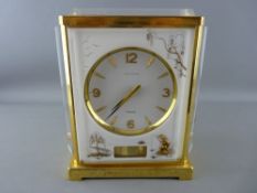 A JAEGER LE COULTRE ATMOS MARINA MANTEL CLOCK, gilt brass frame and plexi glass panels with white