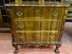 A GOOD REPRODUCTION WALNUT THREE DRAWER CHEST with shaped top and drawers on ball and claw supports,
