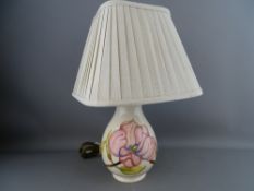 A MOORCROFT 'MAGNOLIA' TABLE LAMP decorated on a cream ground, impressed factory marks, with pleated