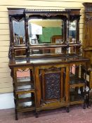 A LATE 19th CENTURY ROSEWOOD & EBONIZED MIRRORED BACK SIDE CABINET having spindle galleries,