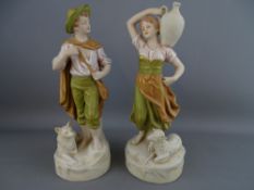 A PAIR OF ROYAL DUX ORNAMENTAL FIGURINES of a young man and his dog and a vessel carrying maiden