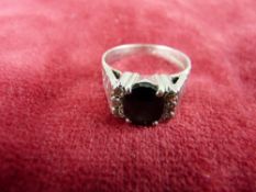 AN EIGHTEEN CARAT WHITE GOLD BLACK SAPPHIRE & SIX SMALL DIAMONDS RING, 7 grms, size 'P'