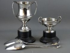 A GEORGE III SILVER SERVING SPOON & ONE OTHER with two silver twin handled trophies on stands,