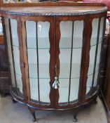 A 20th century walnut display cabinet