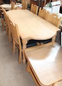 An oak dining suite comprising a dining table, eight chairs, wall unit, bookcase,