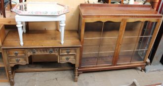 A mahogany display cabinet together with an oak dressing table,