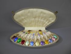 A Set of Twelve Scandinavian Silver Gilt and Enamel Harlequin Teaspoons with matching sugar tongs in