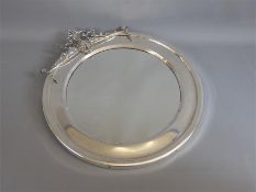 A Circular Chrome Framed Mirror