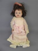 A Porcelain Doll Dressed in Pink Clothes