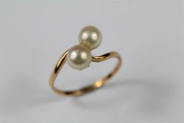 A Yellow Gold and Pearl Cross Over Ring