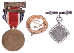 LOT WITHDRAWN - A Contemporary 9ct gold circular scroll brooch