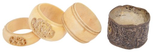 Two late 19th century carved ivory Cantonese napkin rings and two others