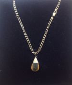 A contemporary amber tear drop pendant on fancy 9ct gold chain