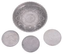 Three Chinese silver dollars and a Chinese silver dish inset with a Chinese dollar,