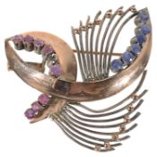 A Continental Art Deco style gold coloured sapphire and ruby brooch