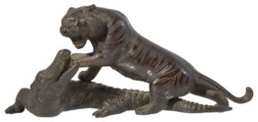 A late 19th century Japanese bronze of a tiger attacking a crocodile probably by Genryusai Seiya