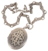 A large Victorian silver locket on fancy neck chain