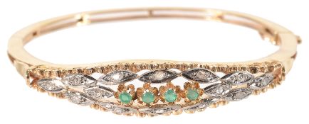 A Continental 18K gold emerald and diamond hinged bangle