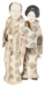 A late 19th century Japanese Meji period ivory Okimono of a lady and a gentleman