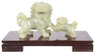 A contemporary celadon jade carving of a kyrin and young